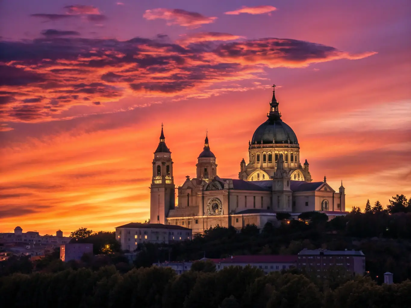 A photograph of a historical landmark in Bourges, beautifully lit at night, during a heritage celebration event.